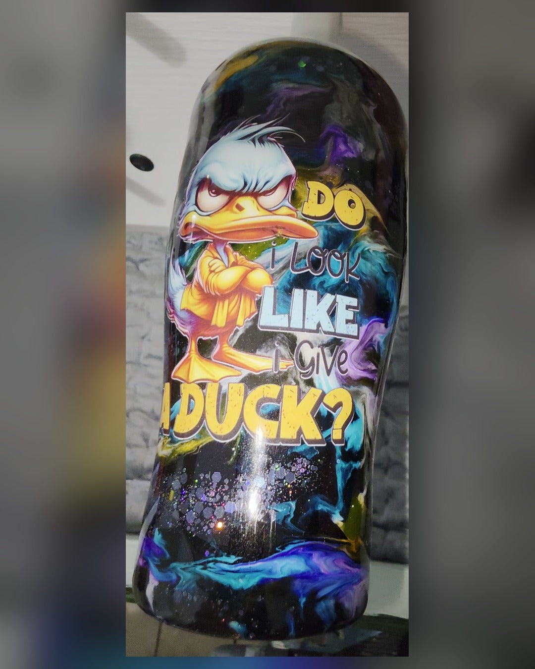 Front view of sassy angry duck tumbler with Do I Look Like I Give a Duck text and holo glitter